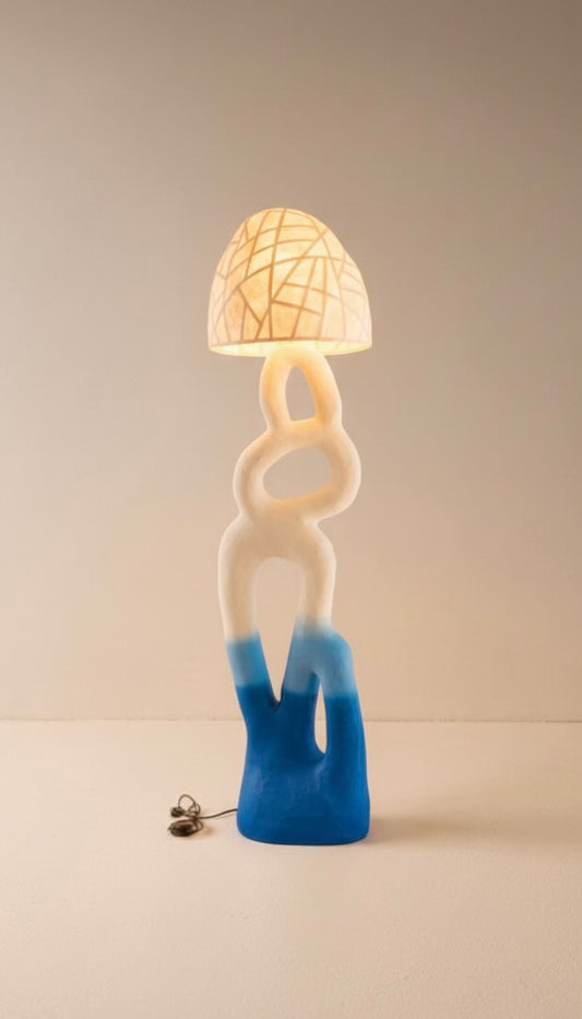 Unusual unique lamp with a blue base and white body on a beige background